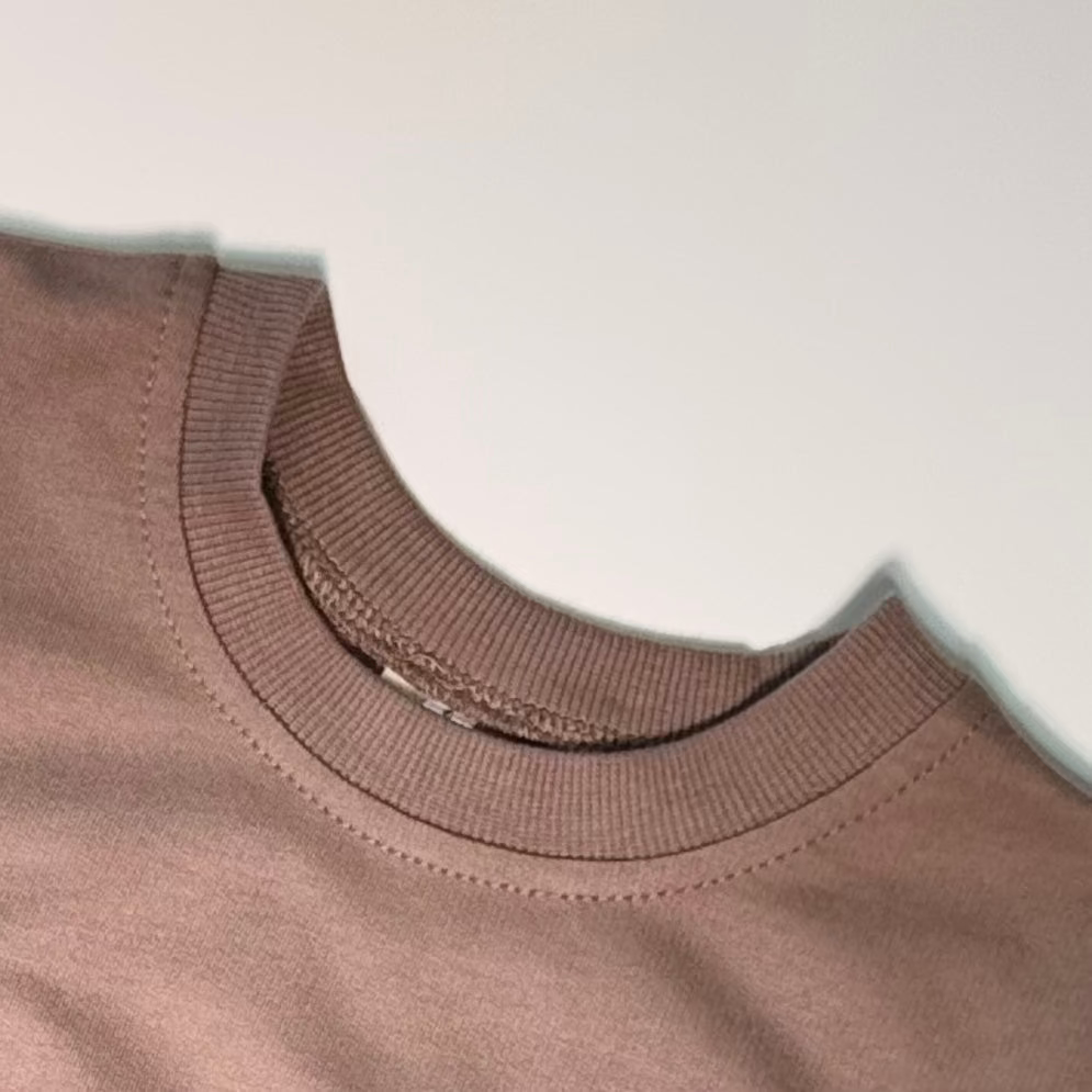 Close-up of a brown garment with a white background